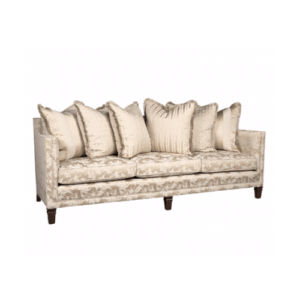 Elegant cream-colored three-seater sofa featuring a subtle patterned fabric, dark tapered wooden legs, and a collection of matching decorative throw pillows with fringe and stripe details on a white background.