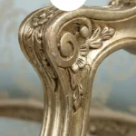 Close-up detail of mahogany wood furniture chair featuring a hand-carved spiral twist design with a high-gloss polished finish.
