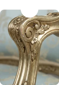 Close-up detail of mahogany wood furniture chair featuring a hand-carved spiral twist design with a high-gloss polished finish.